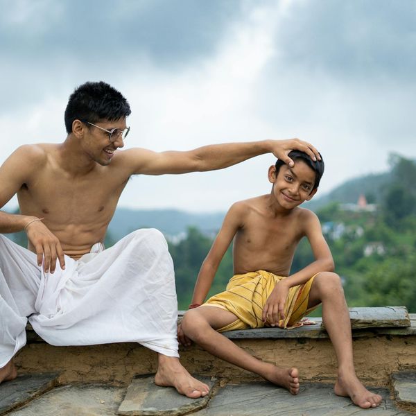 Person sitting in a lotus pose against a calm, natural background.